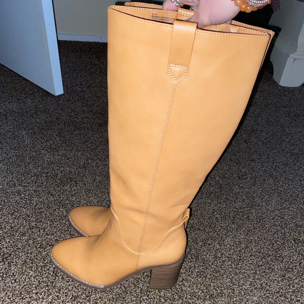 Knee high boots tag still on